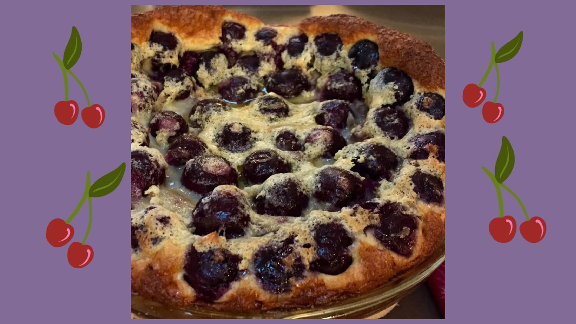 a golden brown dark cherry clafloutis on purple background