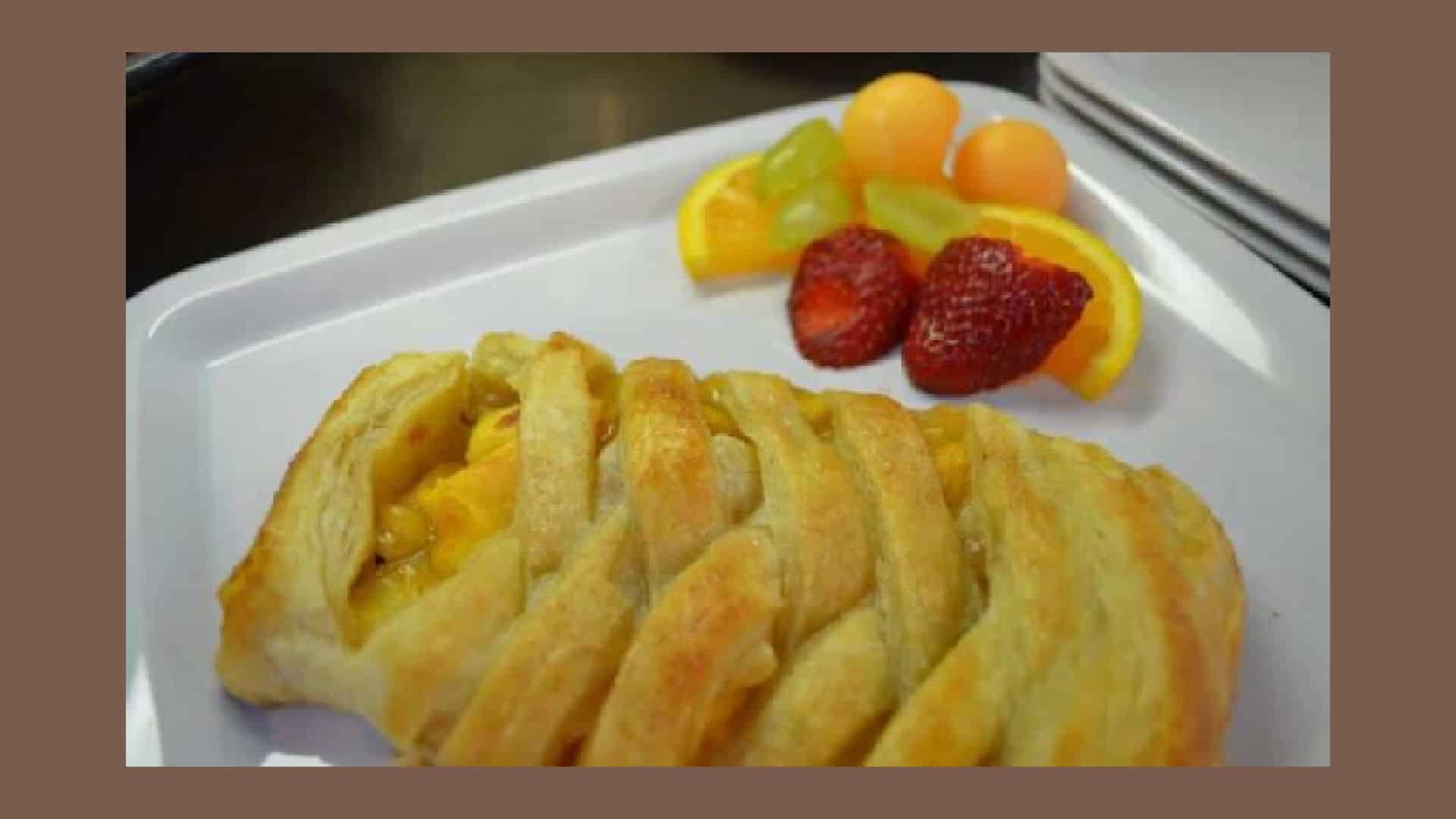 Peach Strudel on a white plate with fresh fruit