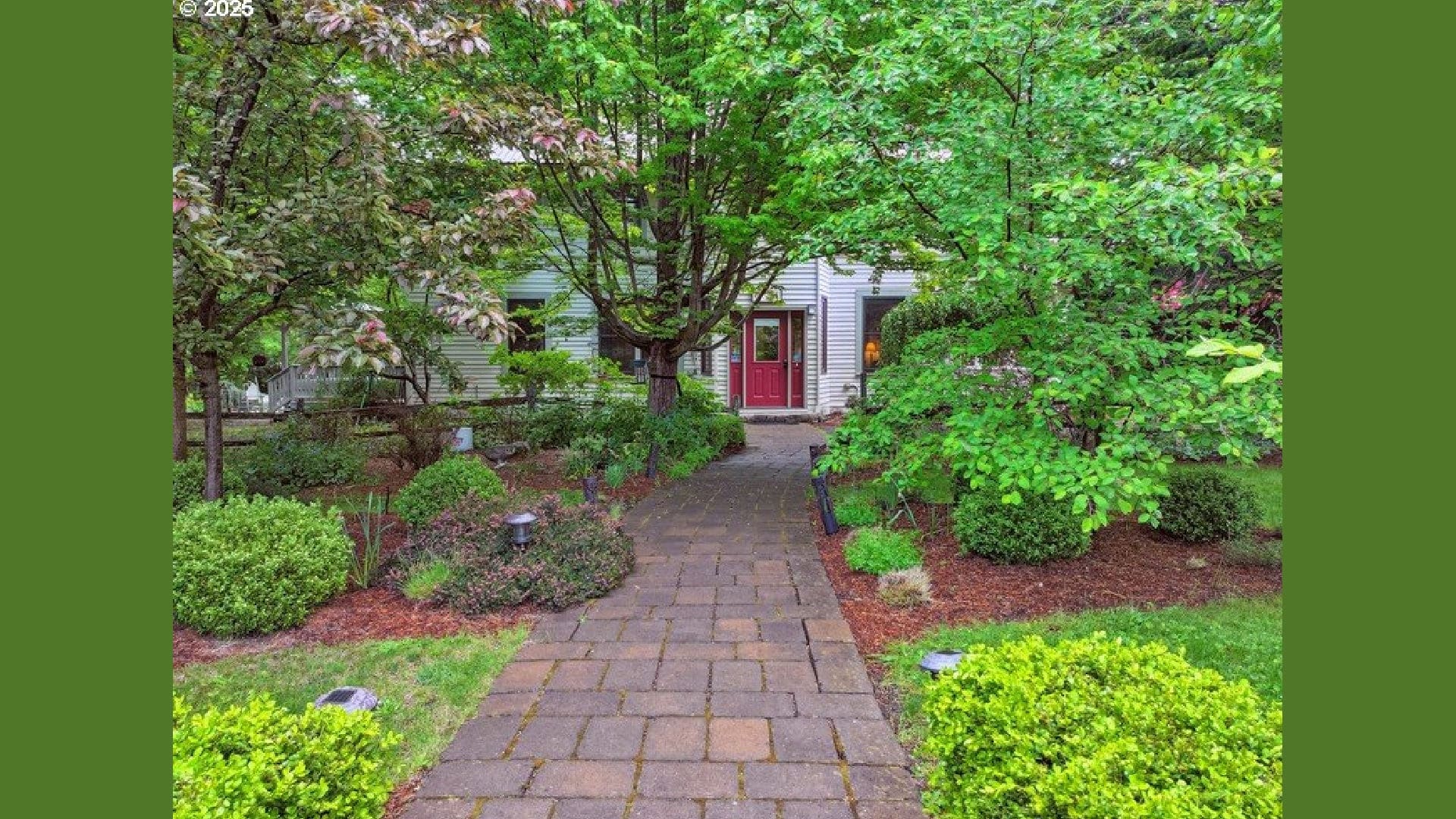 Red Door entry through the lush gardens
