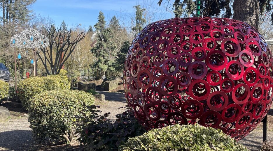 A large red Bing Cherry Sculpture in Milwaukie Oregon Sculpture Garden